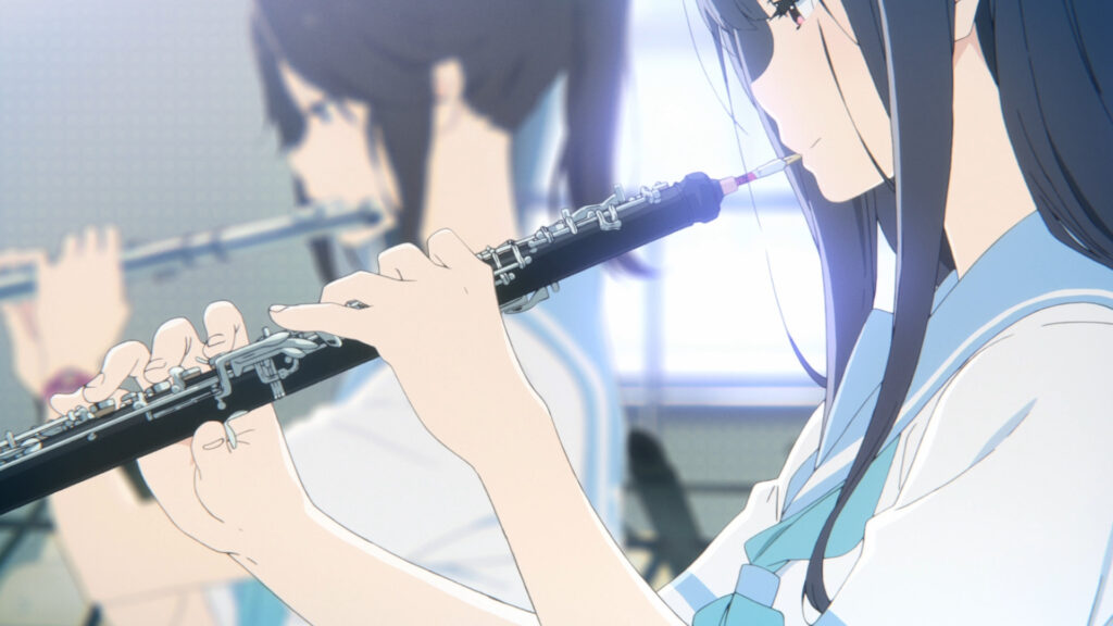 Screenshot from Liz and the Blue Bird, showing the two main protagonists practicing oboe and flute